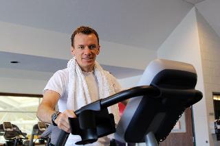 Man exercising on a treadmill smiling